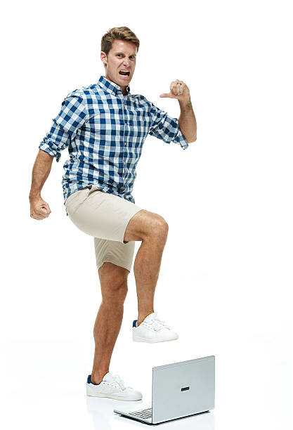 istock Angry casual man kicking the laptop 505159558