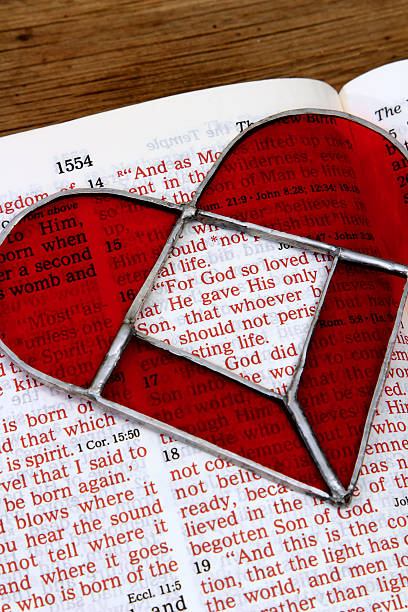 istock Religious: open Bible Scripture of John 3:16 with red heart 505159784