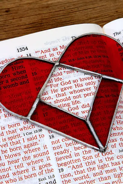 Photo of Religious: open Bible Scripture of John 3:16 with red heart