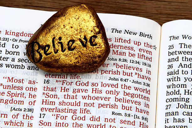 istock Religious: open Bible Scripture of John 3:16 with Believe stone 505160036