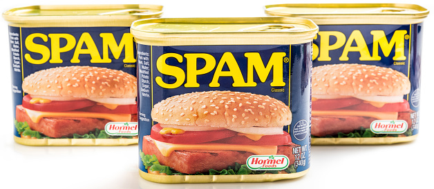 Miami, Florida, USA- May 27, 2015: Three 12 ounces cans of Clasic SPAM isolated on a white background. Spam stands for Spiced Pork and Ham, which is a canned precooked meat product. It is made by the Hormel Foods Corporation and was introduced in 1937.