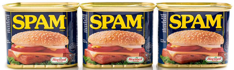 Miami, Florida, USA- May 27, 2015: Three 12 ounces cans of Clasic SPAM isolated on a white background. Spam stands for Spiced Pork and Ham, which is a canned precooked meat product. It is made by the Hormel Foods Corporation and was introduced in 1937.