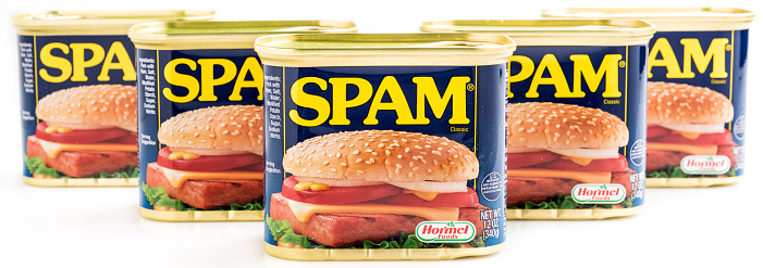 Miami, Florida, USA- May 27, 2015: Five 12 ounces cans of Clasic SPAM isolated on a white background. Spam stands for Spiced Pork and Ham, which is a canned precooked meat product. It is made by the Hormel Foods Corporation and was introduced in 1937.