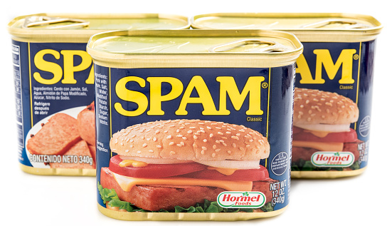 Miami, Florida, USA- May 27, 2015: Three 12 ounces cans of Clasic SPAM isolated on a white background. Spam stands for Spiced Pork and Ham, which is a canned precooked meat product. It is made by the Hormel Foods Corporation and was introduced in 1937.