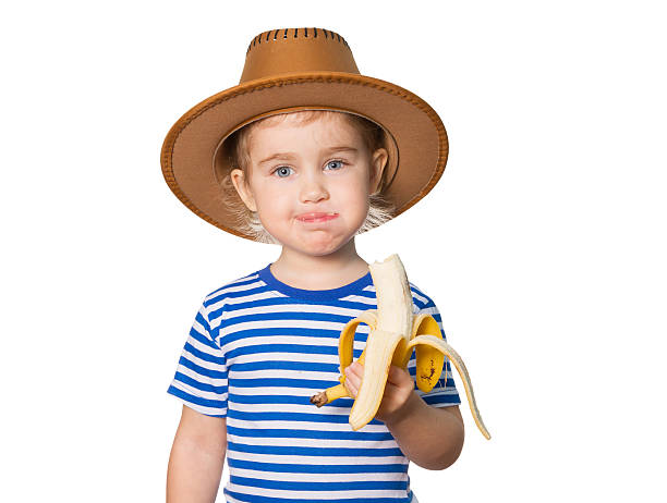 istock Little Funny girl eats banana. 505161834