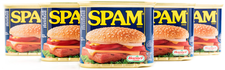 Miami, Florida, USA- May 27, 2015: Five 12 ounces cans of Clasic SPAM isolated on a white background. Spam stands for Spiced Pork and Ham, which is a canned precooked meat product. It is made by the Hormel Foods Corporation and was introduced in 1937.