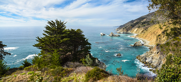 Coastal scene of Big Sur State park on a warm sunny morning with light rays, California.