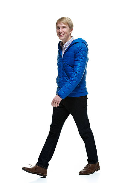 istock Smiling man in winter clothing and walking 505167150