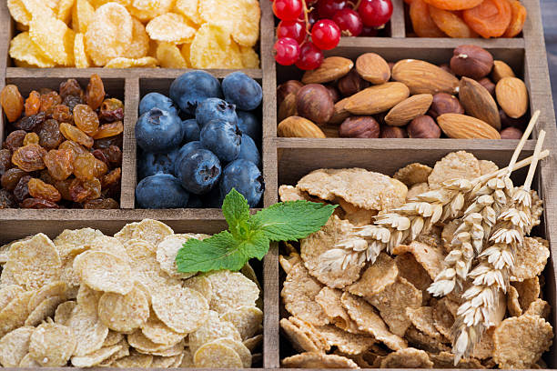 istock breakfast cereal, dried fruit, berries and nuts in wooden box 505167316