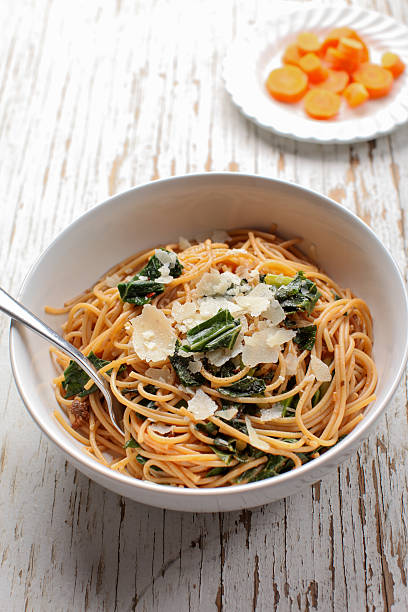istock Kale, Tomato and Parmesan pasta dish with steamed carrots 505167318