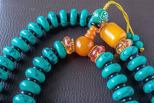 istock ethnic beads of various colors on a book 505167876