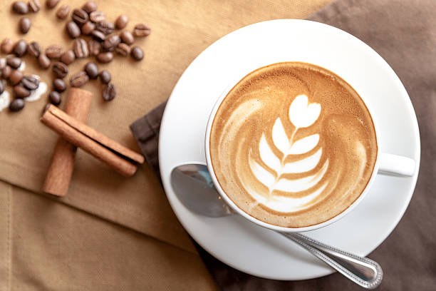 istock Cup of cafe' latte with coffee beans and cinnamon sticks 505168094