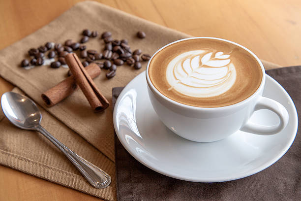 istock Cup of cafe' latte with coffee beans and cinnamon sticks 505168194