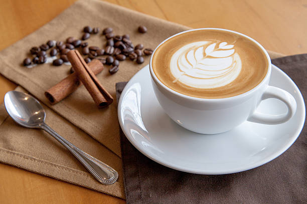 istock Cup of cafe' latte with coffee beans and cinnamon sticks 505168264
