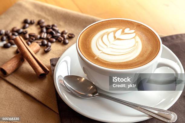 Cup Of Cafe Latte With Coffee Beans And Cinnamon Sticks Stock Photo - Download Image Now