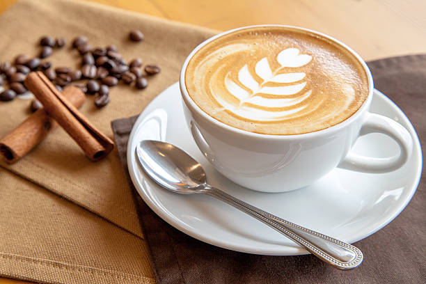 istock Cup of cafe' latte with coffee beans and cinnamon sticks 505168390