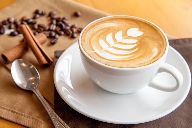 istock Cup of cafe' latte with coffee beans and cinnamon sticks 505168438