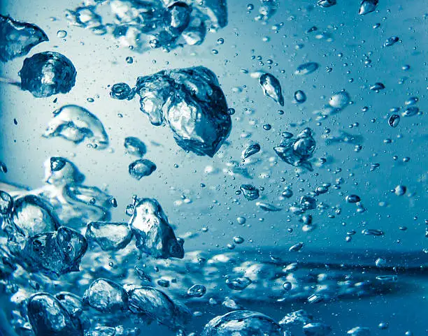 Boiled clean blue mineral water with air bubbles