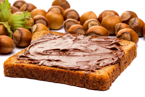 istock Bread with sweet chocolate hazelnut spread isolated on white 505169196