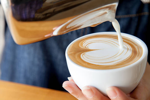 Pouring latte art into the cup Pouring latte art into the cup milk froth stock pictures, royalty-free photos & images