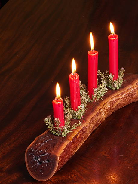 istock Four candles in a timber plank with Christmas decoration 505169604