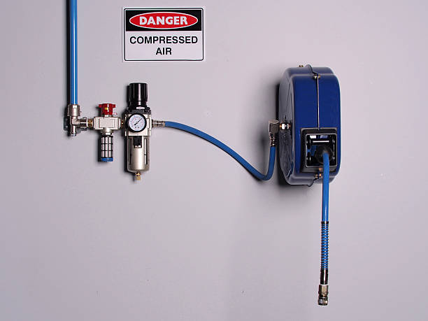 Fixed color coded compressed air line with pressure regulator Fixed color coded compressed air line with pressure regulator, scale and flexibly hose reel, wall mounted, Melbourne 2015 retractable photos stock pictures, royalty-free photos & images