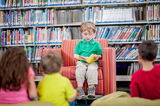 istock Little Boy Reading to His Peers 505170972
