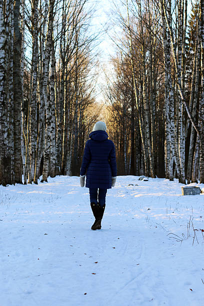 istock woman walk park winter snow back 505171404