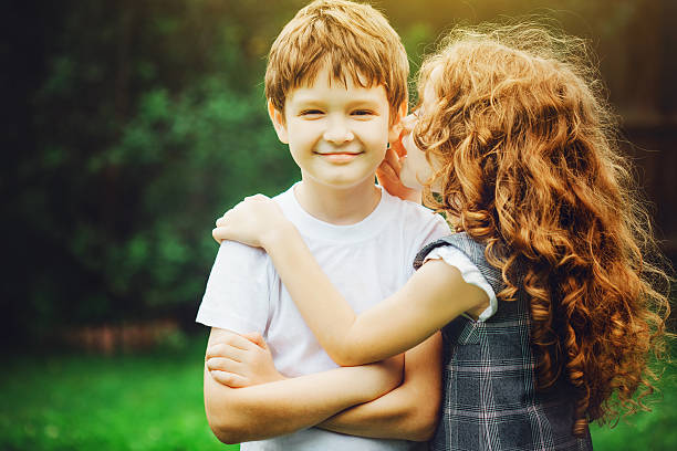 istock Little boy and girl telling whispers 505172200