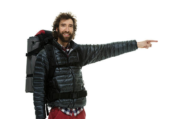 istock Smiling hiker standing and pointing away 505172466