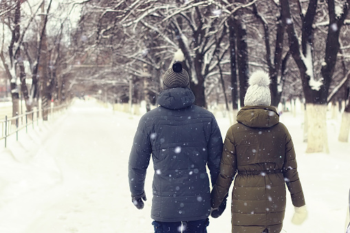 young couple walking road winter