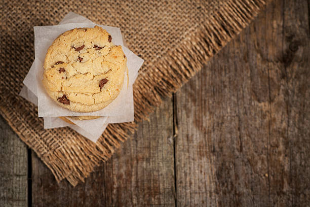 istock Stack of cookies wrapped in paper on a wooden background 505174400