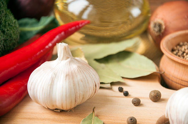 Chile pepper, garlic, onions, broccoli, coriander, cloves, olive oil stock photo