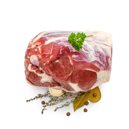 Raw lamb leg with bone, spices, isolated on white, top view