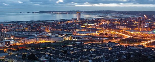 Dusk at Swansea city An evening view of Swansea centre and the Bay area taken from Kilvey Hill January 2016 swansea stock pictures, royalty-free photos & images