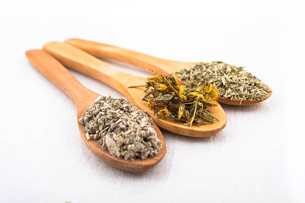 Herbal teas Three wooden spoons with different tea herbs. rosemary dry spice herbal medicine stock pictures, royalty-free photos & images