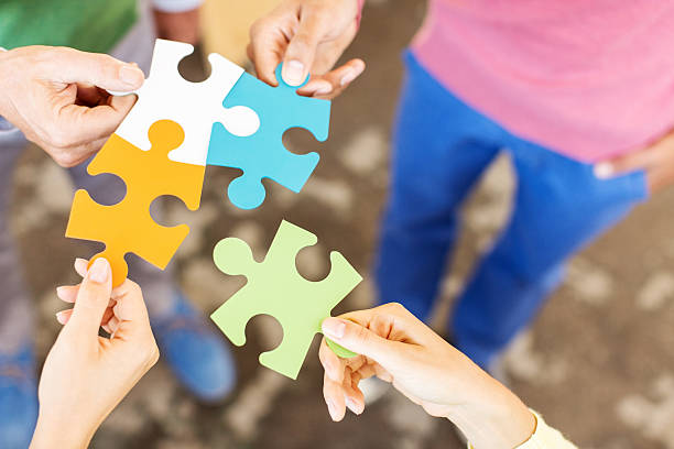Creative Business People Holding Jigsaw Pieces