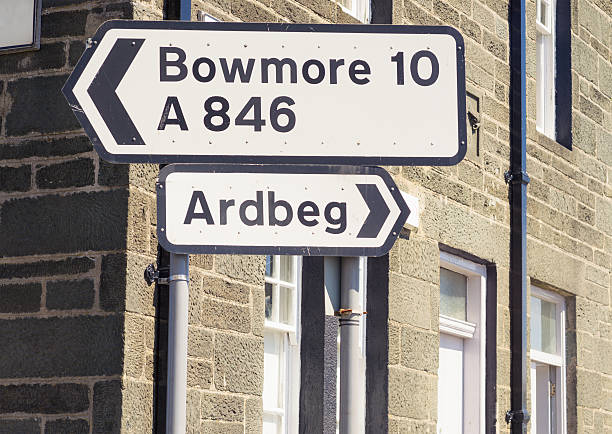 Signs for Bowmore and Ardbeg on Islay Signs for the villages of Bowmore and Ardbeg on the Inner Hebridean island of Islay in Scotland. bowmore whisky stock pictures, royalty-free photos & images