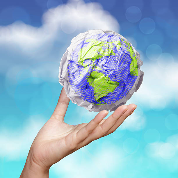istock hand showing crumpled world paper symbol 505197425