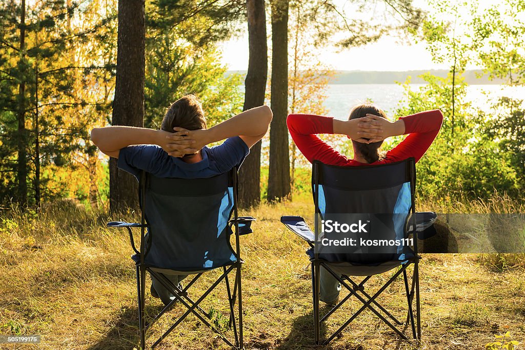 man and woman resting on the lake Camping Stock Photo