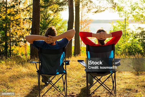 Man And Woman Resting On The Lake Stock Photo - Download Image Now - Camping, Chair, Activity