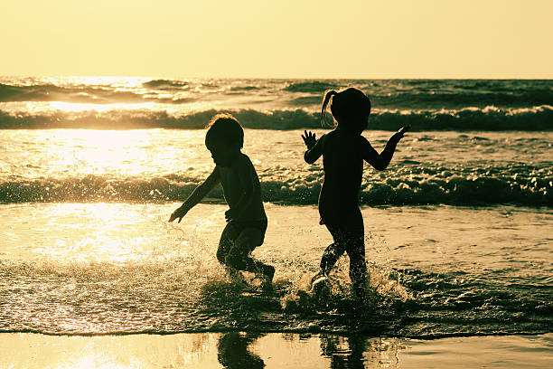 istock two happy kids playing on the beach 505199207