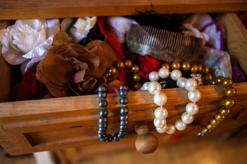 Necklaces protruding from open drawer