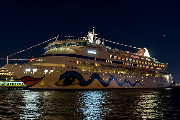 San Juan, Puerto Rico - February 11, 2015: Cruise ship AIDAvita docked in the San Juan cruise port. AIDAvita is one of a fleet of 10 cruise ships belonging to AIDA Cruises, the German Cruise Line based in Rostock, Germany which is a subsidiary of Carnival Corporation & plc.People can be seen on deck enjoying the view of San Juan.