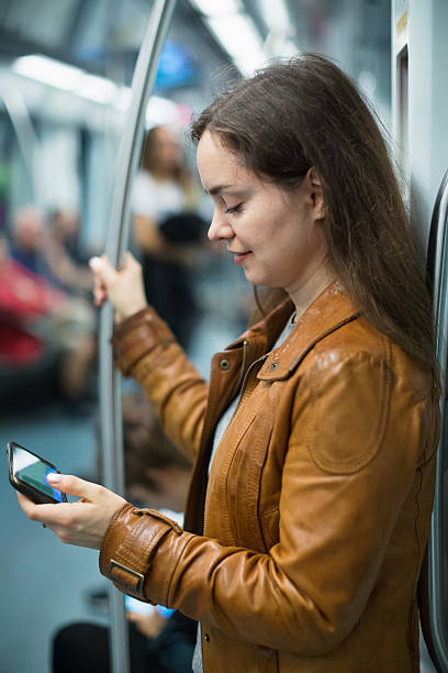 istock Young smiling woman reading from mobile phone screen 505207664