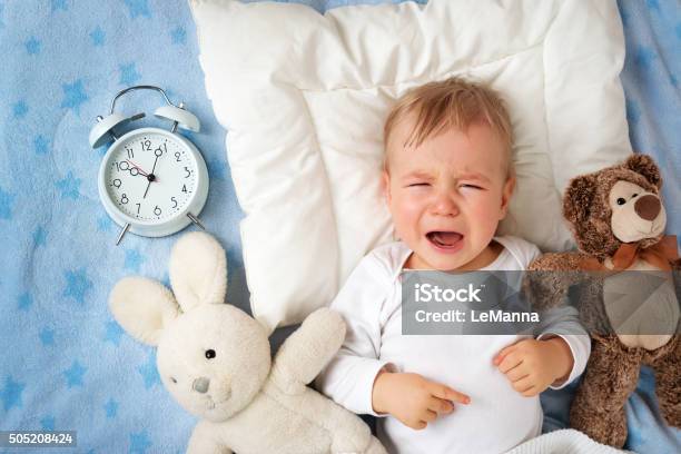 One Year Old Baby With Alarm Clock Stock Photo - Download Image Now - Baby - Human Age, Crying, Child