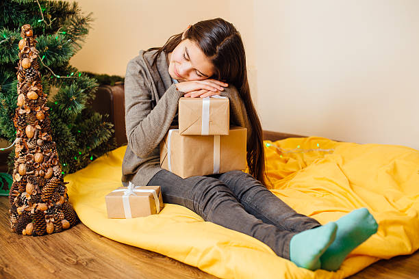 istock Little child sleeping with her presents 505209310