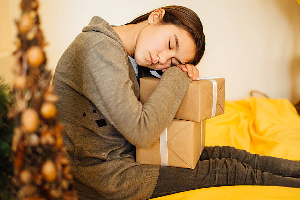 istock Little child sleeping with her presents 505209646