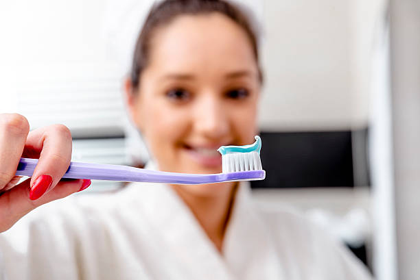 istock Beautiful woman cleaning her teeth 505209748