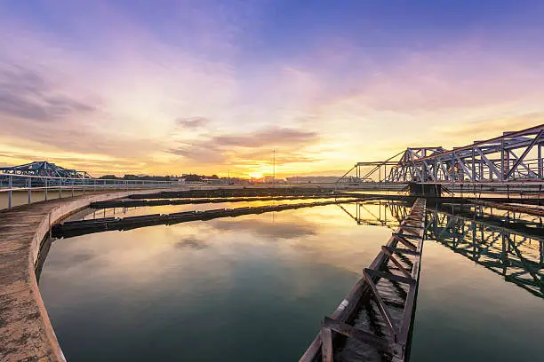 Clarifier tank in sewage treatment plant with sunrise